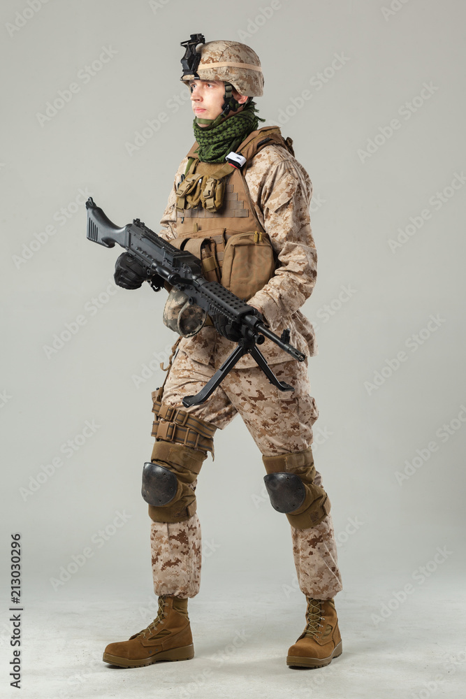 Soldier in camouflage holding rifle Soldier in camouflage holding rifle
