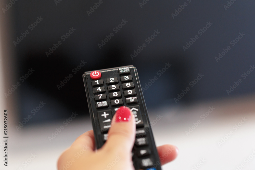 Watching TV and using remote controller Watching TV and using remote controller