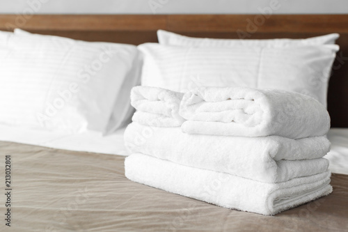 White towel on bed in guest room for hotel customer © fotofabrika