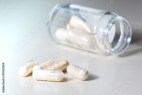 Yellow transparent  Probiotics  capsule in glass bottle photo