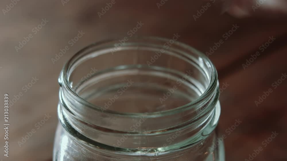 Sweet tea poured into a mason jar centered in frame. Sweet tea poured into a mason jar centered in frame.