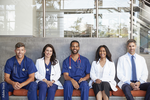 Healthcare workers sitting in hospital, three quarter length photo