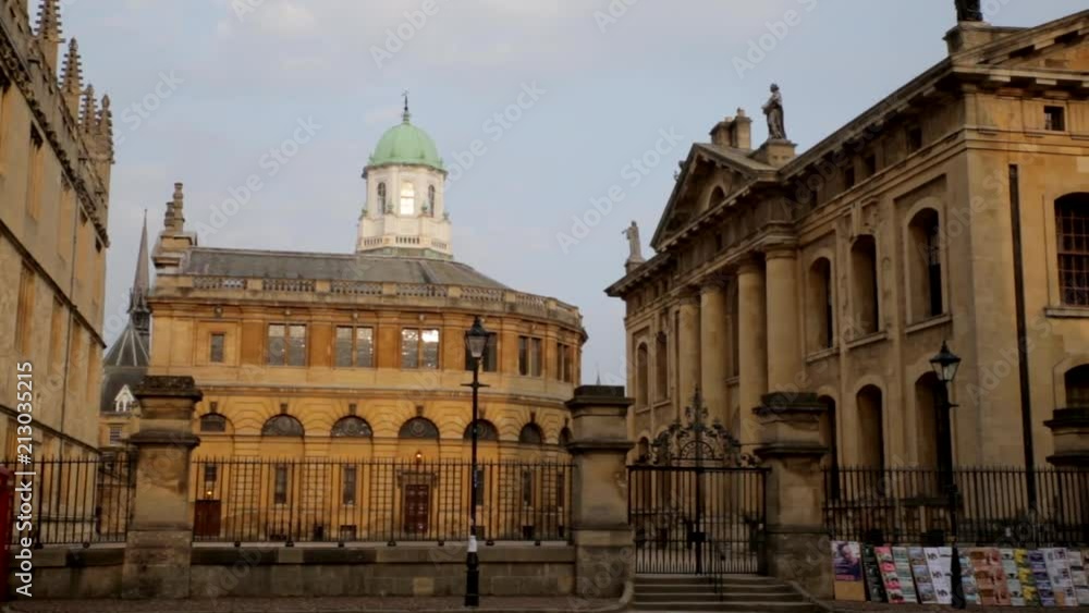 Pan right from Bodleian Library via Sheldonian Theatre and back of Clarendon Building POV from Queen's Lane across Catte Street at the golden hour Pan right from Bodleian Library via Sheldonian Theatre and back of Clarendon Building POV from Queen's Lane across Catte Street at the golden hour