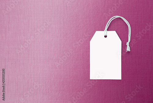 Blank paper price tag on pink paper texture background, business concept background, sale and promotion background