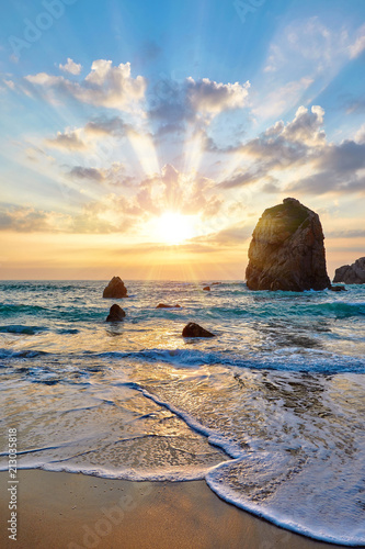 Sand beach among rocks on evening sunset. Ursa near Cape Roca