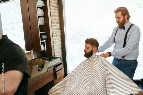 Men Hair Salon. Man Getting Haircut In Barber Shop