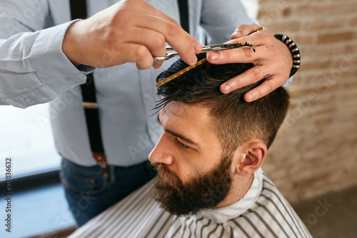 Men Haircut. Barber Cutting Man's Hair In Barber Shop 
