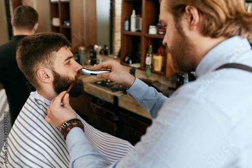 Barber Shop. Man Gets Beard Hair Cut