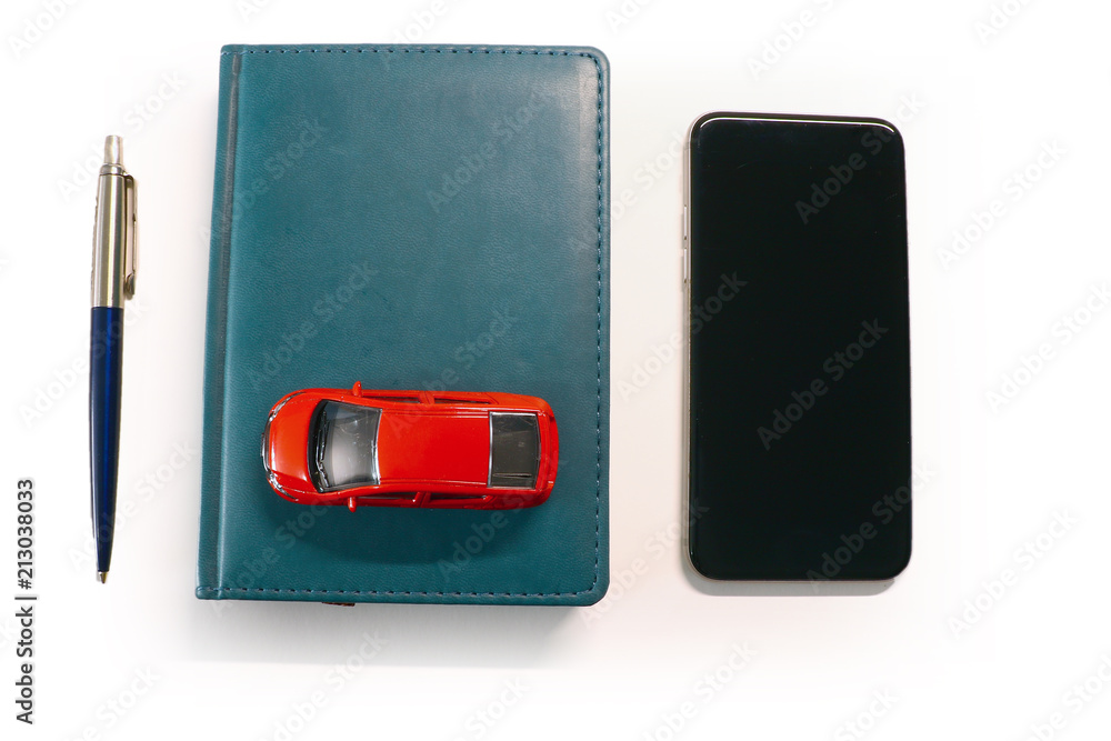 car, smartphone and notebook on a light background car, smartphone and notebook on a light background