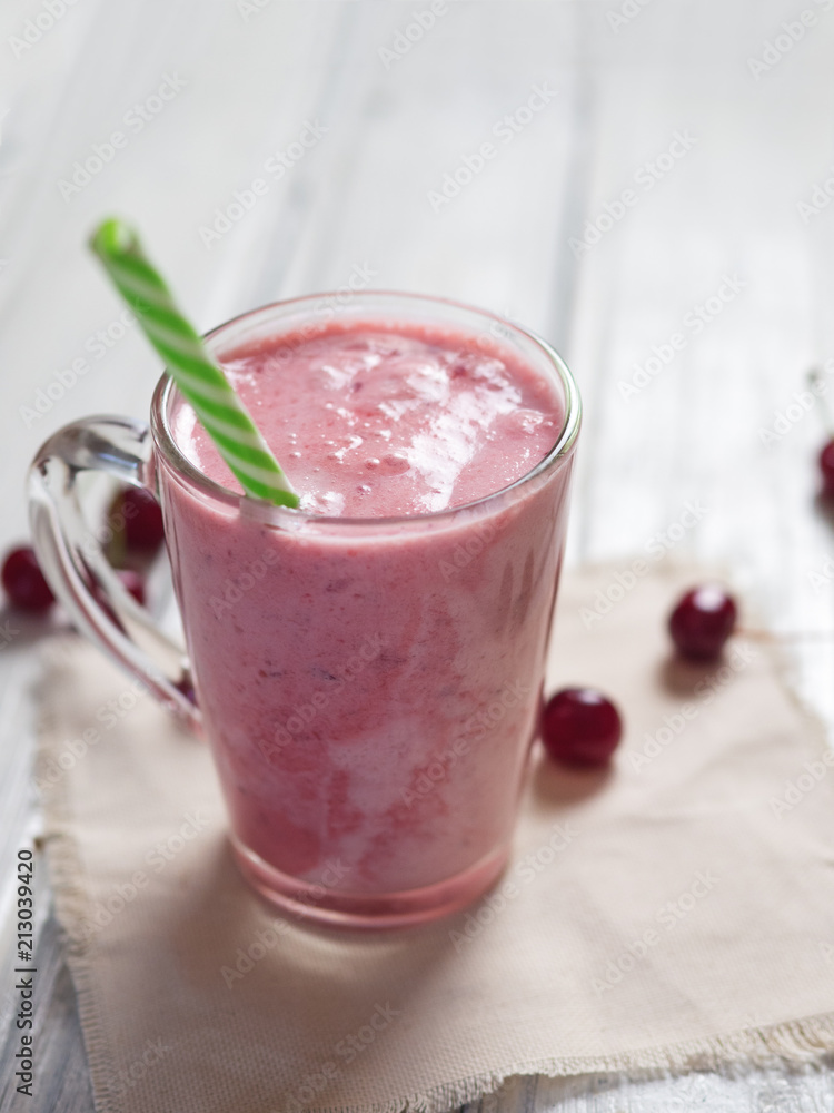 Milkshake or cherry smoothie on white wooden table. Wholesome breakfast Milkshake or cherry smoothie on white wooden table. Wholesome breakfast