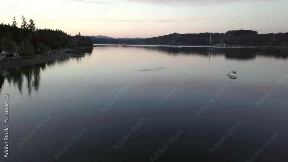 backwards aerial reveal of abandoned boat in bay in PNW backwards aerial reveal of abandoned boat in bay in PNW