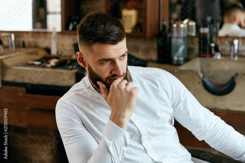 Man With Beard And Hairstyle In Barber Shop.