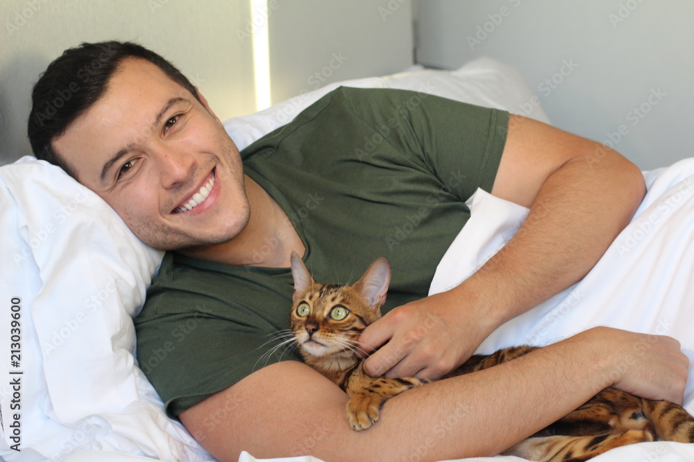 Cute ethnic man sleeping with his cat Cute ethnic man sleeping with his cat