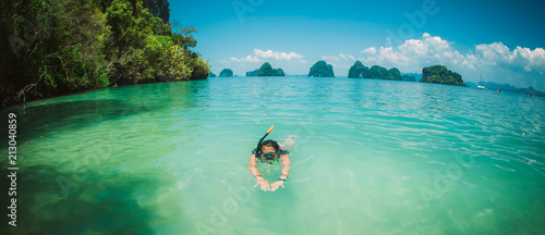 Happy young woman with snorkeling mask enjoying on the beach