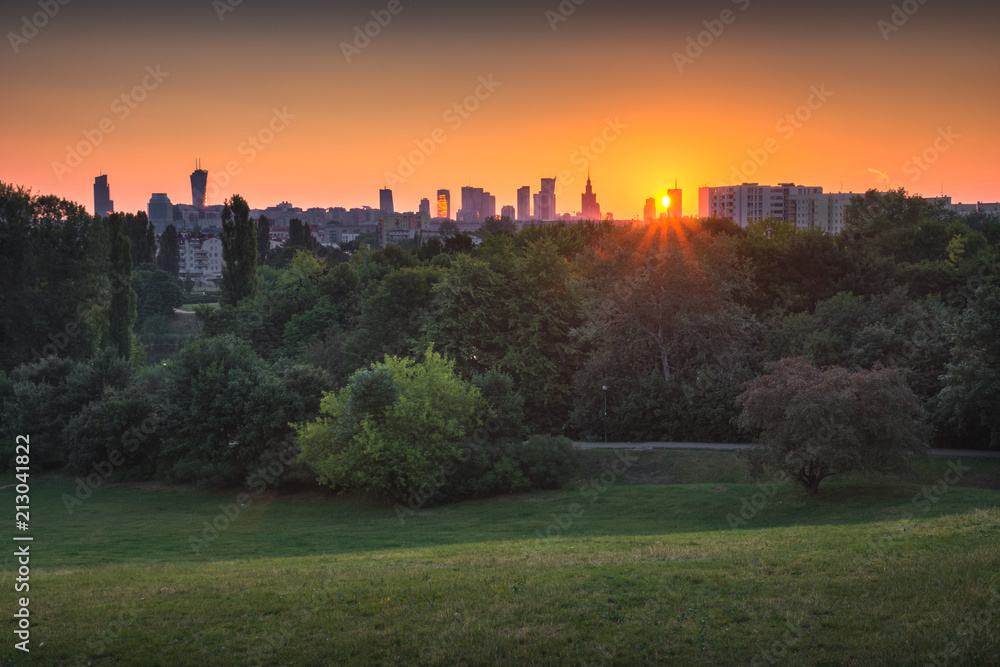 Szczesliwicki park and panorama of skyscrapers in Warsaw at sunrise, Poland