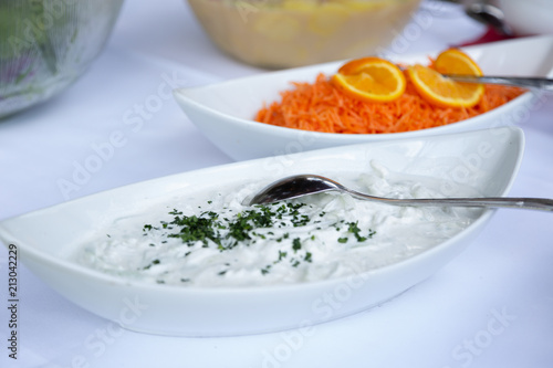 raditional greek dip sauce or dressing tzatziki prepared with grated cucumber sour cream yogurt olive oil and fresh parsley