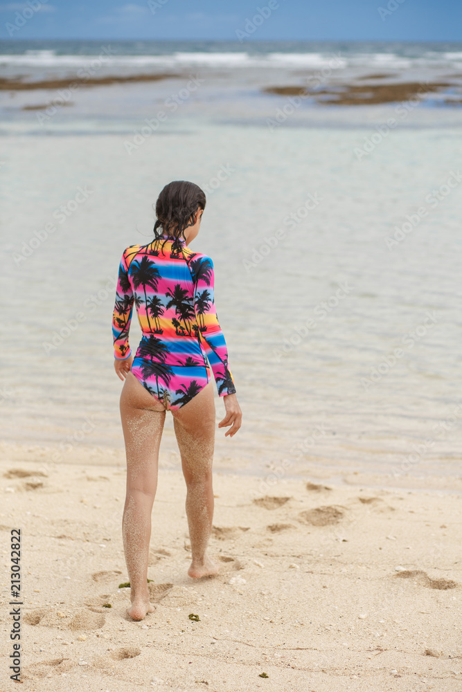 Young, sporty, sexy and beautiful girl in swimsuit resting on exotic beach in summer Young, sporty, sexy and beautiful girl in swimsuit resting on exotic beach in summer