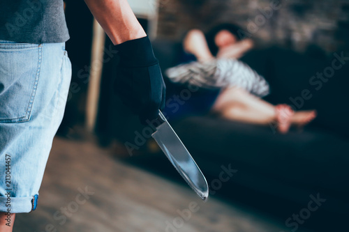 Canvas Print Wicked and evil murderer attempt to kill a woman in danger with a knife - homicide and violence society problem concept