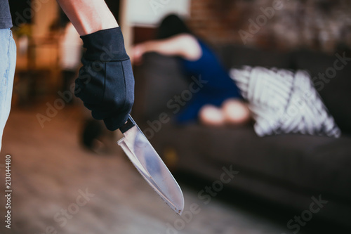 Wicked and evil murderer attempt to kill a woman in danger with a knife - homicide and violence society problem concept. photo