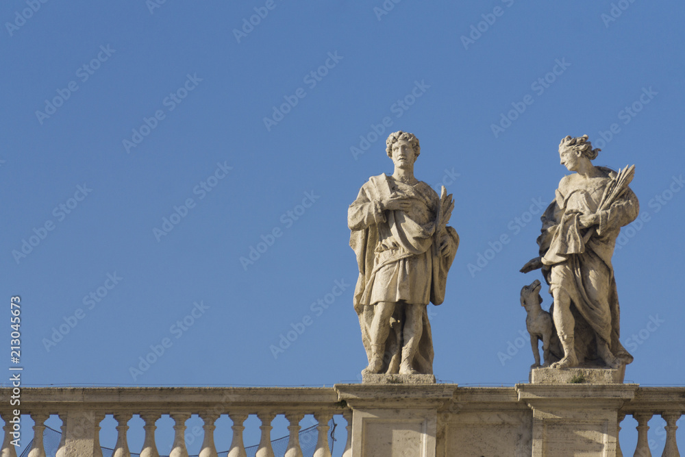 Statues ontop of the colonnades in St Peter's square, Vatican City, Rome, Italy