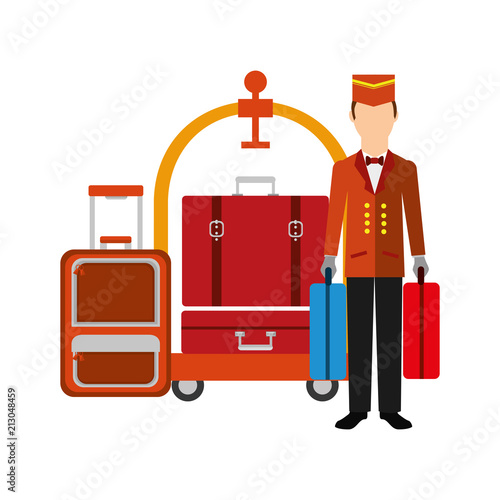 hotel bellboy carrying suitcases and luggage trolley