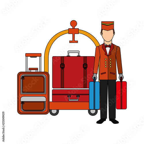 hotel bellboy carrying suitcases and luggage trolley