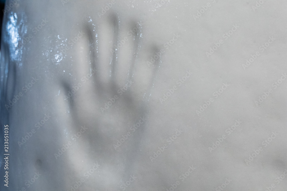 Prints of a human hand on a block of ice. handprint of the passage of man on a glacier.