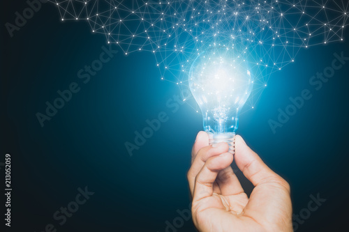 Hand of businessman holding illuminated light bulb, New ideas, innovation and inspiration concepts.