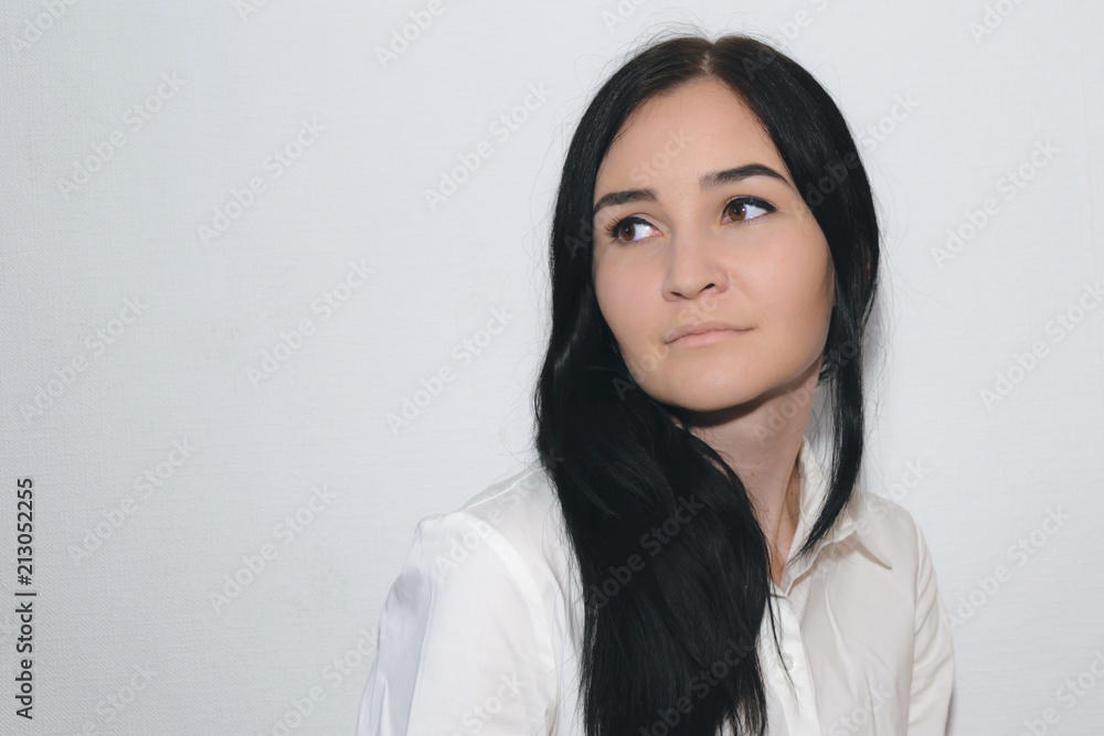 portrait of a girl with black hair, brown eyes, dressed in a white shirt on  a white background Stock Photo | Adobe Stock