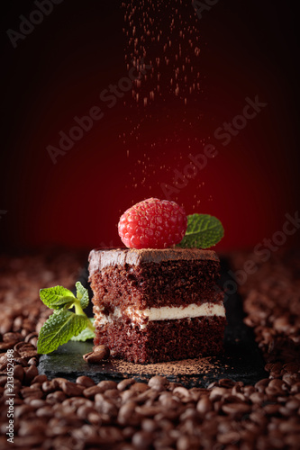 Closeup of chocolate cake with raspberry .
