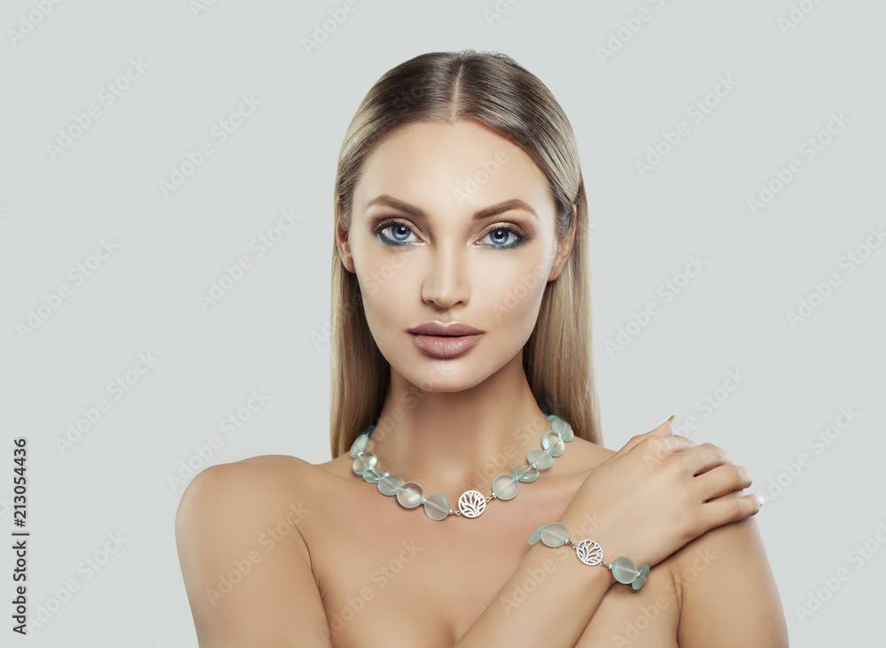 Luxurious Woman Fashion Model with Makeup and Jewelry. Silver Necklace and Bracelet with Semiprecious Stones