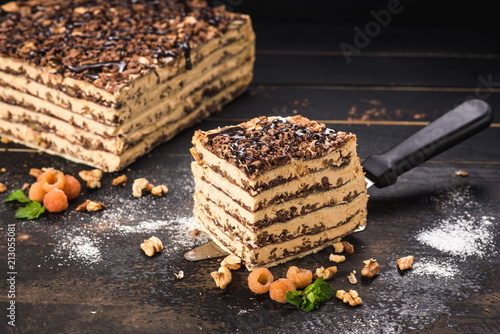 Sweet cake with layers on black background