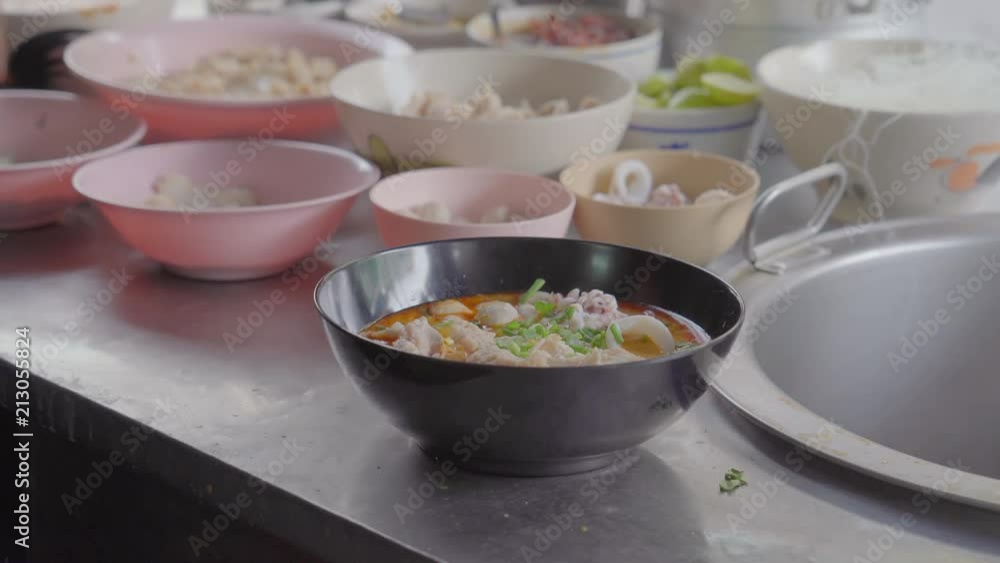 movie shot of a man cooking with charcoal stove. Noodle dish in wok made on open fire. Street food in Chinatown of Bangkok, Thailand movie shot of a man cooking with charcoal stove. Noodle dish in wok made on open fire. Street food in Chinatown of Bangkok, Thailand