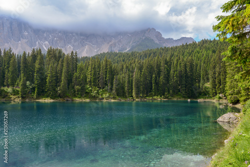 Lake Carezza with reflection of mountains in the Dolomites