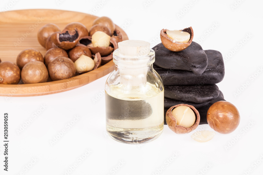 Macadamia nuts oil or Australian walnuts on white background Macadamia nuts oil or Australian walnuts on white background