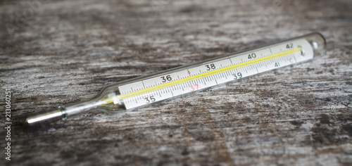 mercury thermometer on wooden table