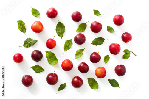 Red and yellow plums pattern on white background