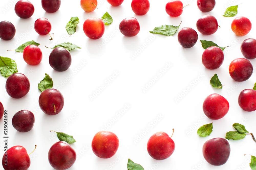 Red and yellow plums pattern on white background. Copyspace Red and yellow plums pattern on white background. Copyspace