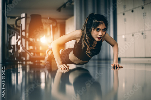 young woman doing push-ups at the gym.