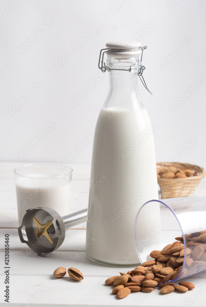 Almond milk on a white wooden table Almond milk on a white wooden table