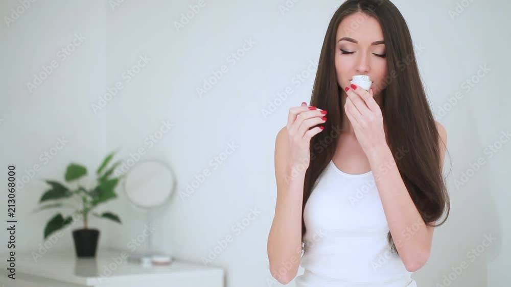 Beauty Face Care. The Portrait of Young Woman With Perfect Skin Applying Cream on Her Skin Beauty Face Care. The Portrait of Young Woman With Perfect Skin Applying Cream on Her Skin