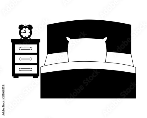 hotel bed and bedside table clock alarm