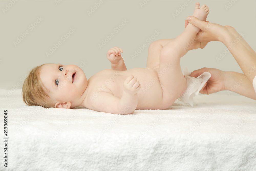 Newborn baby getting a diaper change: mom wiping baby's bottom with baby  wipe Stock Photo | Adobe Stock