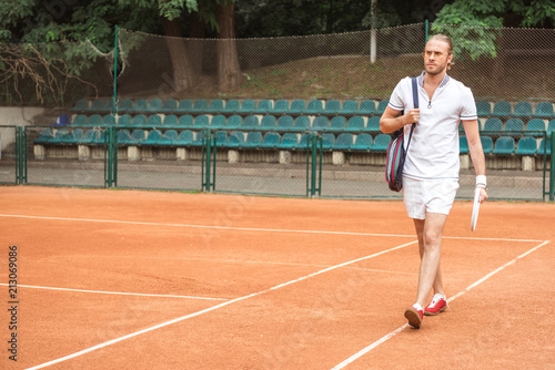 athletic tennis player after training on tennis court