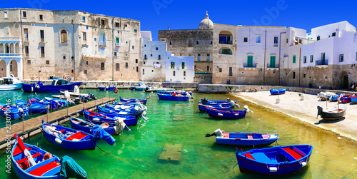 Traditional Italy - white town Monopoli with colorful fishinng boats. Puglia