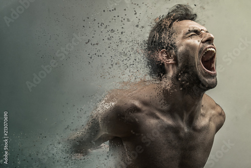 Fotografia Screaming frustrated man dispersing and disintegrating into particles, agonizing