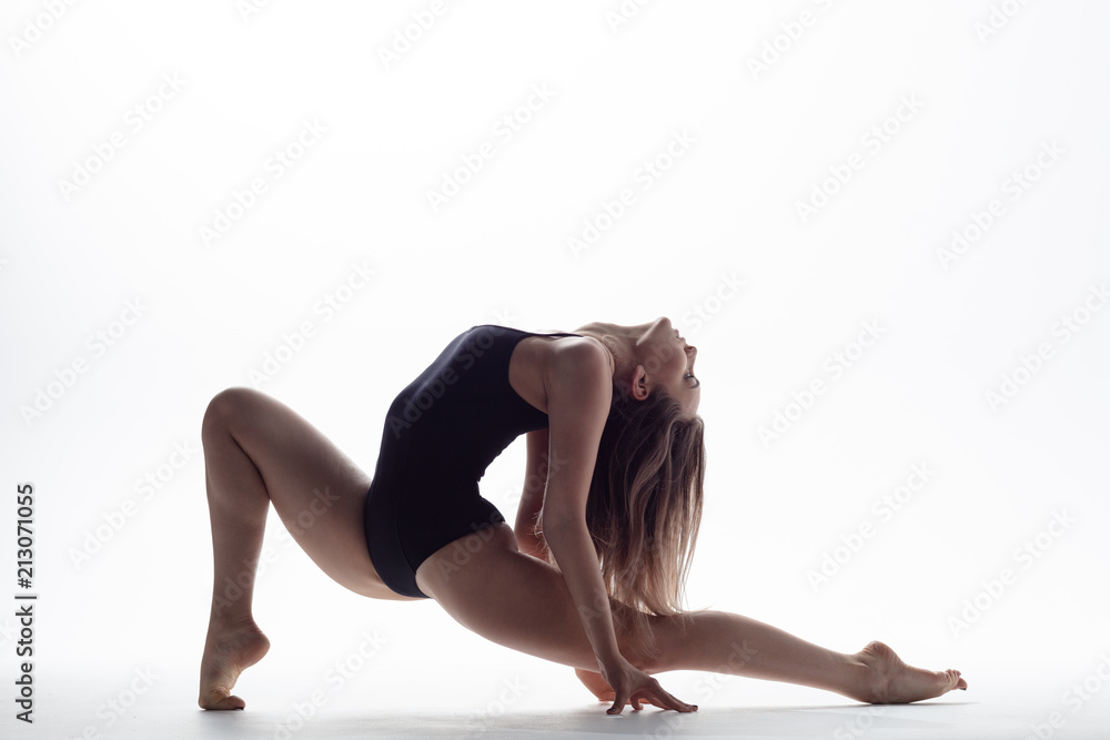 Young beautiful athlete is posing in studio Young beautiful athlete is posing in studio