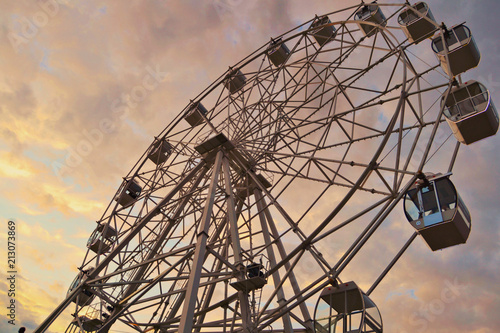Ferris wheel under the soft sky.