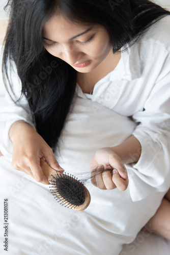 woman looking at her hair for hair loss problem