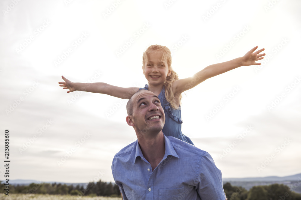 Father spending time with daughter during the sunset. Father spending time with daughter during the sunset.